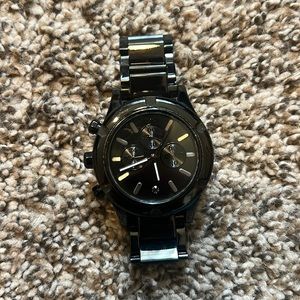 Black women’s Nixon watch with black diamond detail